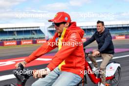 Charles Leclerc (MON) Ferrari rides the circuit with Will Buxton (GBR) F1 Digital Presenter. 04.07.2024. Formula 1 World Championship, Rd 12, British Grand Prix, Silverstone, England, Preparation Day.