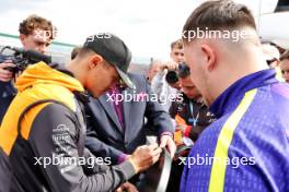 (L to R): Lando Norris (GBR) McLaren with John McDonald (GBR) Darts MC and Luke Littler (GBR) Darts Player. 04.07.2024. Formula 1 World Championship, Rd 12, British Grand Prix, Silverstone, England, Preparation Day.