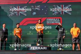 The podium (L to R): Lando Norris (GBR) McLaren, second; Oscar Piastri (AUS) McLaren, race winner; Lewis Hamilton (GBR) Mercedes AMG F1, third; Randy Singh (GBR) McLaren Strategy and Sporting Director. 21.07.2024. Formula 1 World Championship, Rd 13, Hungarian Grand Prix, Budapest, Hungary, Race Day.