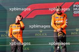 (L to R): Second placed Lando Norris (GBR) McLaren and race winner Oscar Piastri (AUS) McLaren on the podium. 21.07.2024. Formula 1 World Championship, Rd 13, Hungarian Grand Prix, Budapest, Hungary, Race Day.