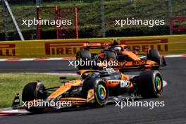 Oscar Piastri (AUS) McLaren MCL38 leads team mate Lando Norris (GBR) McLaren MCL38. 21.07.2024. Formula 1 World Championship, Rd 13, Hungarian Grand Prix, Budapest, Hungary, Race Day.