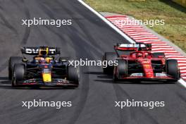 Max Verstappen (NLD) Red Bull Racing RB20 and Charles Leclerc (MON) Ferrari SF-24 battle for position. 21.07.2024. Formula 1 World Championship, Rd 13, Hungarian Grand Prix, Budapest, Hungary, Race Day.