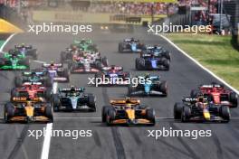 (L to R): Oscar Piastri (AUS) McLaren MCL38; Lando Norris (GBR) McLaren MCL38; and Max Verstappen (NLD) Red Bull Racing RB20, at the start of the race. 21.07.2024. Formula 1 World Championship, Rd 13, Hungarian Grand Prix, Budapest, Hungary, Race Day.
