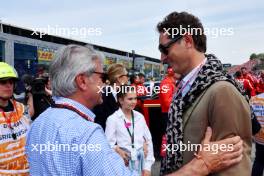 (L to R): Carlos Sainz (ESP) with John Elkann (ITA) FIAT Chrysler Automobiles Chairman on the grid. 19.05.2024. Formula 1 World Championship, Rd 7, Emilia Romagna Grand Prix, Imola, Italy, Race Day.