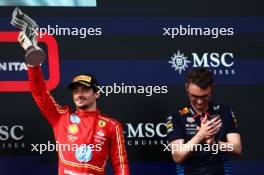 Charles Leclerc (MON) Ferrari celebrates his third position on the podium with David Morgan (GBR) Red Bull Racing Aero Trackside Performance Team Leader. 19.05.2024. Formula 1 World Championship, Rd 7, Emilia Romagna Grand Prix, Imola, Italy, Race Day.