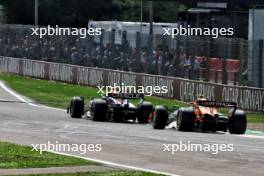Sergio Perez (MEX) Red Bull Racing RB20 leads Lando Norris (GBR) McLaren MCL38. 19.05.2024. Formula 1 World Championship, Rd 7, Emilia Romagna Grand Prix, Imola, Italy, Race Day.