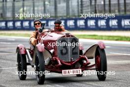 George Russell (GBR) Mercedes AMG F1 and Timo Glock (GER) in vintage race overalls in a 1924 Targa Florio Mercedes racing car. 16.05.2024. Formula 1 World Championship, Rd 7, Emilia Romagna Grand Prix, Imola, Italy, Preparation Day.
