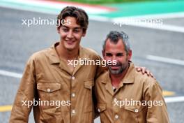 (L to R): George Russell (GBR) Mercedes AMG F1 and Timo Glock (GER) in vintage race overalls. 16.05.2024. Formula 1 World Championship, Rd 7, Emilia Romagna Grand Prix, Imola, Italy, Preparation Day.