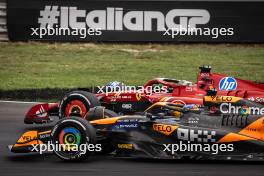 Race winner Charles Leclerc (MON) Ferrari SF-24 celebrates at the end of the race with Oscar Piastri (AUS) McLaren MCL38. 01.09.2024. Formula 1 World Championship, Rd 16, Italian Grand Prix, Monza, Italy, Race Day.