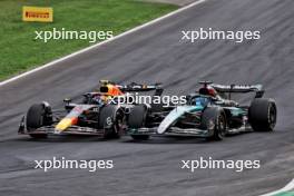 Sergio Perez (MEX) Red Bull Racing RB20 and George Russell (GBR) Mercedes AMG F1 W15 battle for position. 01.09.2024. Formula 1 World Championship, Rd 16, Italian Grand Prix, Monza, Italy, Race Day.