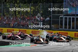 Lando Norris (GBR) McLaren MCL38 leads team mate Oscar Piastri (AUS) McLaren MCL38 at the start of the race as George Russell (GBR) Mercedes AMG F1 W15 runs wide. 01.09.2024. Formula 1 World Championship, Rd 16, Italian Grand Prix, Monza, Italy, Race Day.