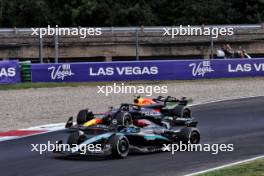 Sergio Perez (MEX) Red Bull Racing RB20 and George Russell (GBR) Mercedes AMG F1 W15 battle for position. 01.09.2024. Formula 1 World Championship, Rd 16, Italian Grand Prix, Monza, Italy, Race Day.