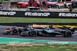 Sergio Perez (MEX) Red Bull Racing RB20 and George Russell (GBR) Mercedes AMG F1 W15 battle for position. 01.09.2024. Formula 1 World Championship, Rd 16, Italian Grand Prix, Monza, Italy, Race Day.