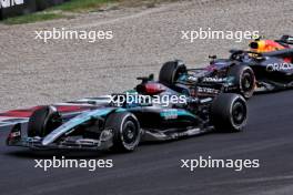 Sergio Perez (MEX) Red Bull Racing RB20 and George Russell (GBR) Mercedes AMG F1 W15 battle for position. 01.09.2024. Formula 1 World Championship, Rd 16, Italian Grand Prix, Monza, Italy, Race Day.