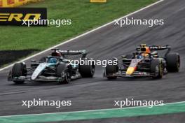 George Russell (GBR) Mercedes AMG F1 W15 and Sergio Perez (MEX) Red Bull Racing RB20 battle for position. 01.09.2024. Formula 1 World Championship, Rd 16, Italian Grand Prix, Monza, Italy, Race Day.