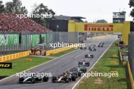 George Russell (GBR) Mercedes AMG F1 W15 and Sergio Perez (MEX) Red Bull Racing RB20 battle for position. 01.09.2024. Formula 1 World Championship, Rd 16, Italian Grand Prix, Monza, Italy, Race Day.