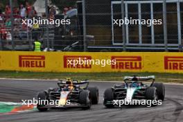 Sergio Perez (MEX) Red Bull Racing RB20 and George Russell (GBR) Mercedes AMG F1 W15 battle for position. 01.09.2024. Formula 1 World Championship, Rd 16, Italian Grand Prix, Monza, Italy, Race Day.