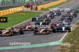 Lando Norris (GBR) McLaren MCL38 leads team mate Oscar Piastri (AUS) McLaren MCL38 at the start of the race as George Russell (GBR) Mercedes AMG F1 W15 runs wide. 01.09.2024. Formula 1 World Championship, Rd 16, Italian Grand Prix, Monza, Italy, Race Day.