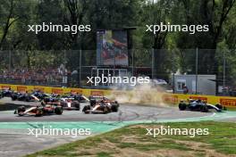 Lando Norris (GBR) McLaren MCL38 leads team mate Oscar Piastri (AUS) McLaren MCL38 at the start of the race as George Russell (GBR) Mercedes AMG F1 W15 runs wide. 01.09.2024. Formula 1 World Championship, Rd 16, Italian Grand Prix, Monza, Italy, Race Day.