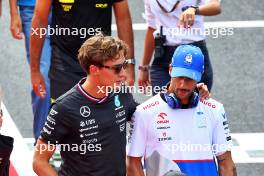 (L to R): George Russell (GBR) Mercedes AMG F1 with Daniel Ricciardo (AUS) RB on the drivers' parade. 01.09.2024. Formula 1 World Championship, Rd 16, Italian Grand Prix, Monza, Italy, Race Day.