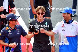 (L to R): Sergio Perez (MEX) Red Bull Racing with George Russell (GBR) Mercedes AMG F1 and Daniel Ricciardo (AUS) RB on the drivers' parade. 01.09.2024. Formula 1 World Championship, Rd 16, Italian Grand Prix, Monza, Italy, Race Day.