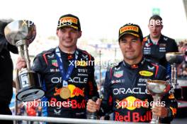 (L to R): Race winner Max Verstappen (NLD) Red Bull Racing celebrates on the podium with second placed team mate Sergio Perez (MEX) Red Bull Racing. 07.04.2024. Formula 1 World Championship, Rd 4, Japanese Grand Prix, Suzuka, Japan, Race Day.
