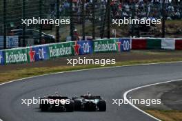 Carlos Sainz Jr (ESP) Ferrari SF-24 and Lewis Hamilton (GBR) Mercedes AMG F1 W15 battle for position. 07.04.2024. Formula 1 World Championship, Rd 4, Japanese Grand Prix, Suzuka, Japan, Race Day.