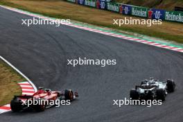 Carlos Sainz Jr (ESP) Ferrari SF-24 and George Russell (GBR) Mercedes AMG F1 W15 battle for position. 07.04.2024. Formula 1 World Championship, Rd 4, Japanese Grand Prix, Suzuka, Japan, Race Day.