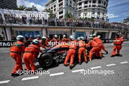 The Red Bull Racing RB20 of Sergio Perez (MEX) Red Bull Racing removed by marshals after the race stopping start crash. 26.05.2024. Formula 1 World Championship, Rd 8, Monaco Grand Prix, Monte Carlo, Monaco, Race Day.