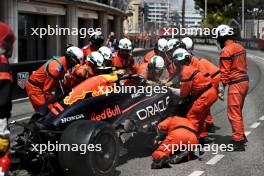 The Red Bull Racing RB20 of Sergio Perez (MEX) Red Bull Racing removed by marshals after the race stopping start crash. 26.05.2024. Formula 1 World Championship, Rd 8, Monaco Grand Prix, Monte Carlo, Monaco, Race Day.