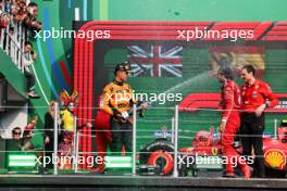 (L to R): Lando Norris (GBR) McLaren celebrates his second position on the podium with race winner Carlos Sainz Jr (ESP) Ferrari and Riccardo Adami (ITA) Ferrari Race Engineer. 27.10.2024. Formula 1 World Championship, Rd 20, Mexican Grand Prix, Mexico City, Mexico, Race Day.