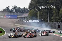 Max Verstappen (NLD) Red Bull Racing RB20 and Carlos Sainz Jr (ESP) Ferrari SF-24 at the start of the race as Yuki Tsunoda (JPN) RB VCARB 01 crashes. 27.10.2024. Formula 1 World Championship, Rd 20, Mexican Grand Prix, Mexico City, Mexico, Race Day.