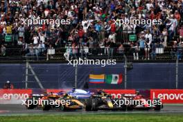 Max Verstappen (NLD) Red Bull Racing RB20 and Carlos Sainz Jr (ESP) Ferrari SF-24 lead at the start of the race as Yuki Tsunoda (JPN) RB VCARB 01 crashes. 27.10.2024. Formula 1 World Championship, Rd 20, Mexican Grand Prix, Mexico City, Mexico, Race Day.