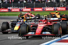 Carlos Sainz Jr (ESP) Ferrari SF-24 leads Max Verstappen (NLD) Red Bull Racing RB20. 27.10.2024. Formula 1 World Championship, Rd 20, Mexican Grand Prix, Mexico City, Mexico, Race Day.