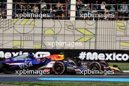 Liam Lawson (NZL) RB VCARB 01 and Sergio Perez (MEX) Red Bull Racing RB20 battle for position. 27.10.2024. Formula 1 World Championship, Rd 20, Mexican Grand Prix, Mexico City, Mexico, Race Day.