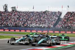 Fernando Alonso (ESP) Aston Martin F1 Team AMR24 and Lance Stroll (CDN) Aston Martin F1 Team AMR24 at the start of the race. 27.10.2024. Formula 1 World Championship, Rd 20, Mexican Grand Prix, Mexico City, Mexico, Race Day.