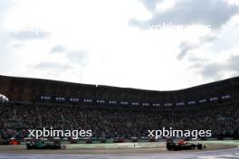 Sergio Perez (MEX) Red Bull Racing RB20 and Lance Stroll (CDN) Aston Martin F1 Team AMR24. 27.10.2024. Formula 1 World Championship, Rd 20, Mexican Grand Prix, Mexico City, Mexico, Race Day.