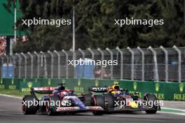 Liam Lawson (NZL) RB VCARB 01 and Sergio Perez (MEX) Red Bull Racing RB20 battle for position. 27.10.2024. Formula 1 World Championship, Rd 20, Mexican Grand Prix, Mexico City, Mexico, Race Day.