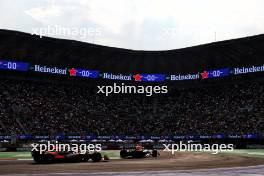 Sergio Perez (MEX) Red Bull Racing RB20 leads Lando Norris (GBR) McLaren MCL38. 26.10.2024. Formula 1 World Championship, Rd 20, Mexican Grand Prix, Mexico City, Mexico, Qualifying Day.