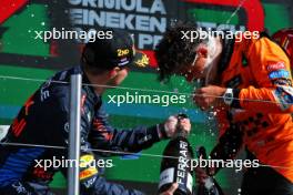 (L to R): Max Verstappen (NLD) Red Bull Racing celebrates his second position with race winner Lando Norris (GBR) McLaren on the podium. 25.08.2024. Formula 1 World Championship, Rd 15, Dutch Grand Prix, Zandvoort, Netherlands, Race Day.