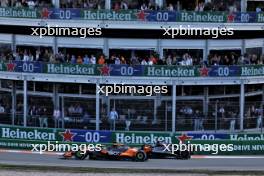 George Russell (GBR) Mercedes AMG F1 W15 and Oscar Piastri (AUS) McLaren MCL38 battle for position. 25.08.2024. Formula 1 World Championship, Rd 15, Dutch Grand Prix, Zandvoort, Netherlands, Race Day.