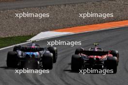 Carlos Sainz Jr (ESP) Ferrari SF-24 and Pierre Gasly (FRA) Alpine F1 Team A524 battle for position. 25.08.2024. Formula 1 World Championship, Rd 15, Dutch Grand Prix, Zandvoort, Netherlands, Race Day.