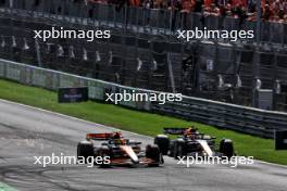 Lando Norris (GBR) McLaren MCL38 passes Max Verstappen (NLD) Red Bull Racing RB20 to take the lead of the race. 25.08.2024. Formula 1 World Championship, Rd 15, Dutch Grand Prix, Zandvoort, Netherlands, Race Day.