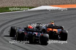 Lando Norris (GBR) McLaren MCL38 passes Max Verstappen (NLD) Red Bull Racing RB20 to take the lead of the race. 25.08.2024. Formula 1 World Championship, Rd 15, Dutch Grand Prix, Zandvoort, Netherlands, Race Day.