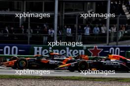 Lando Norris (GBR) McLaren MCL38 passes Max Verstappen (NLD) Red Bull Racing RB20 to take the lead of the race. 25.08.2024. Formula 1 World Championship, Rd 15, Dutch Grand Prix, Zandvoort, Netherlands, Race Day.