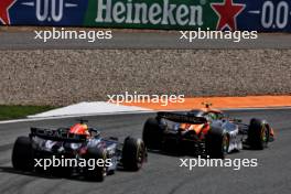 Lando Norris (GBR) McLaren MCL38 passes Max Verstappen (NLD) Red Bull Racing RB20 to take the lead of the race. 25.08.2024. Formula 1 World Championship, Rd 15, Dutch Grand Prix, Zandvoort, Netherlands, Race Day.