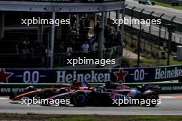 Carlos Sainz Jr (ESP) Ferrari SF-24 and Pierre Gasly (FRA) Alpine F1 Team A524 battle for position. 25.08.2024. Formula 1 World Championship, Rd 15, Dutch Grand Prix, Zandvoort, Netherlands, Race Day.