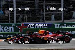 Sergio Perez (MEX) Red Bull Racing RB20 and Carlos Sainz Jr (ESP) Ferrari SF-24 battle for position. 25.08.2024. Formula 1 World Championship, Rd 15, Dutch Grand Prix, Zandvoort, Netherlands, Race Day.