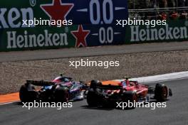 Carlos Sainz Jr (ESP) Ferrari SF-24 and Pierre Gasly (FRA) Alpine F1 Team A524 battle for position. 25.08.2024. Formula 1 World Championship, Rd 15, Dutch Grand Prix, Zandvoort, Netherlands, Race Day.