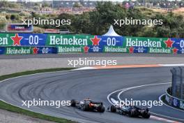 George Russell (GBR) Mercedes AMG F1 W15 and Oscar Piastri (AUS) McLaren MCL38 battle for position. 25.08.2024. Formula 1 World Championship, Rd 15, Dutch Grand Prix, Zandvoort, Netherlands, Race Day.